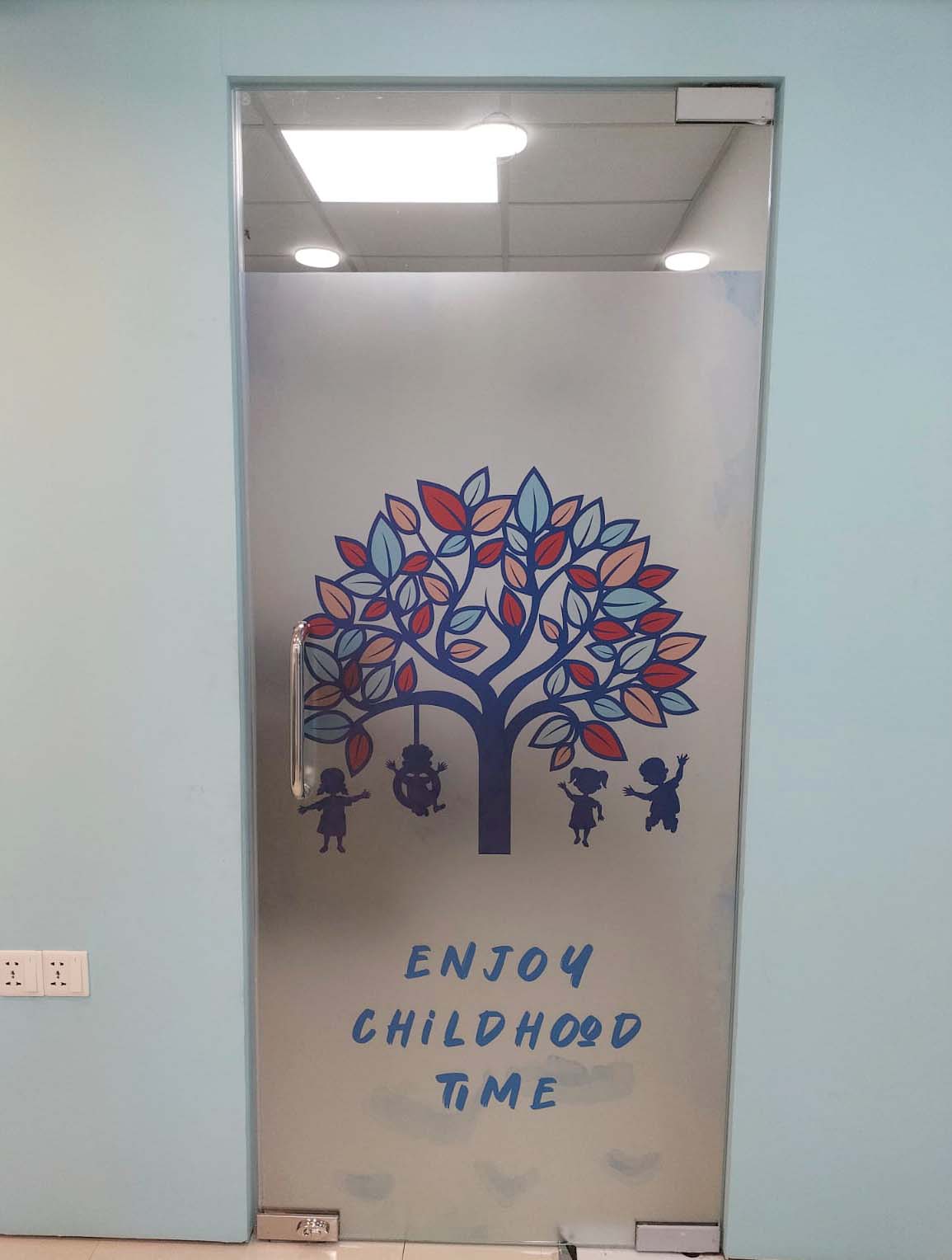 Child therapy room entrance with tree artwork