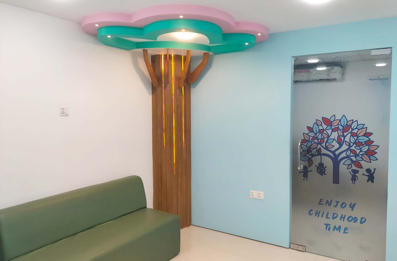 Children's waiting area with decorative tree feature